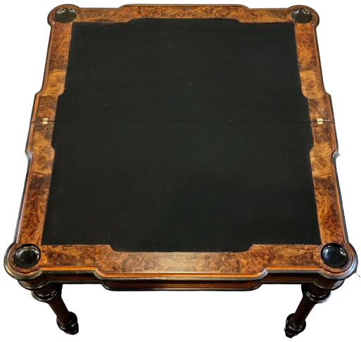Antique French flip-top games table fully extended. The full top is inset with a shaped black baize fabric and the corners feature ebonzied cups for coins and chips.