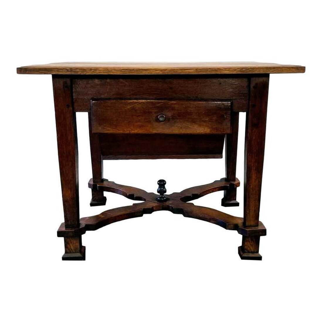Flemish Renaissance oak kitchen work table from the area of Flanders, Northern Belgium. This domestic table from the Low Countries was crafted between 1680 and 1749 using peg construction and features x-form shaped Flemish scroll stretchers with center finial, a Dutch-style faux bois painted ( on back and sides ) possum belly drawer ( originally to store freshly milled flour in the 17th and 18th centuries, now may store anything you please, including potatoes, onions, etc. ), and a side drawer for storage of kitchen implements.The drawers show pre-1750 construction techniques such as applied fronts, equally high sides and backs, through dovetails on backs, bottoms of front-to-back wood grain, and curved front edges. The oak finish is a natural wax. Originally a pastry table or pantry table, this useful piece of furniture may serve as a baker's table, work table, kitchen island, and prep table.