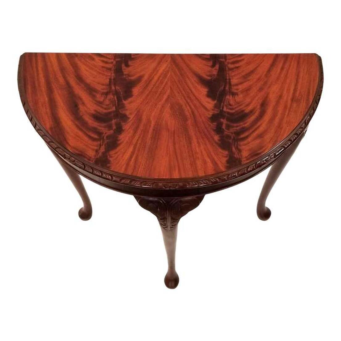 Demi-lune console table features a stunning matched flame, or crotch cut, mahogany veneer top over a straight-cut mahogany base trimmed with a carved border above an apron veneered with straight cut mahogany wood. The three cabriole legs have acanthus scrolls carved into the knees. The legs end in a club foot. Table was manufactured in England in the early years of the 20th century - 1901-1920s.