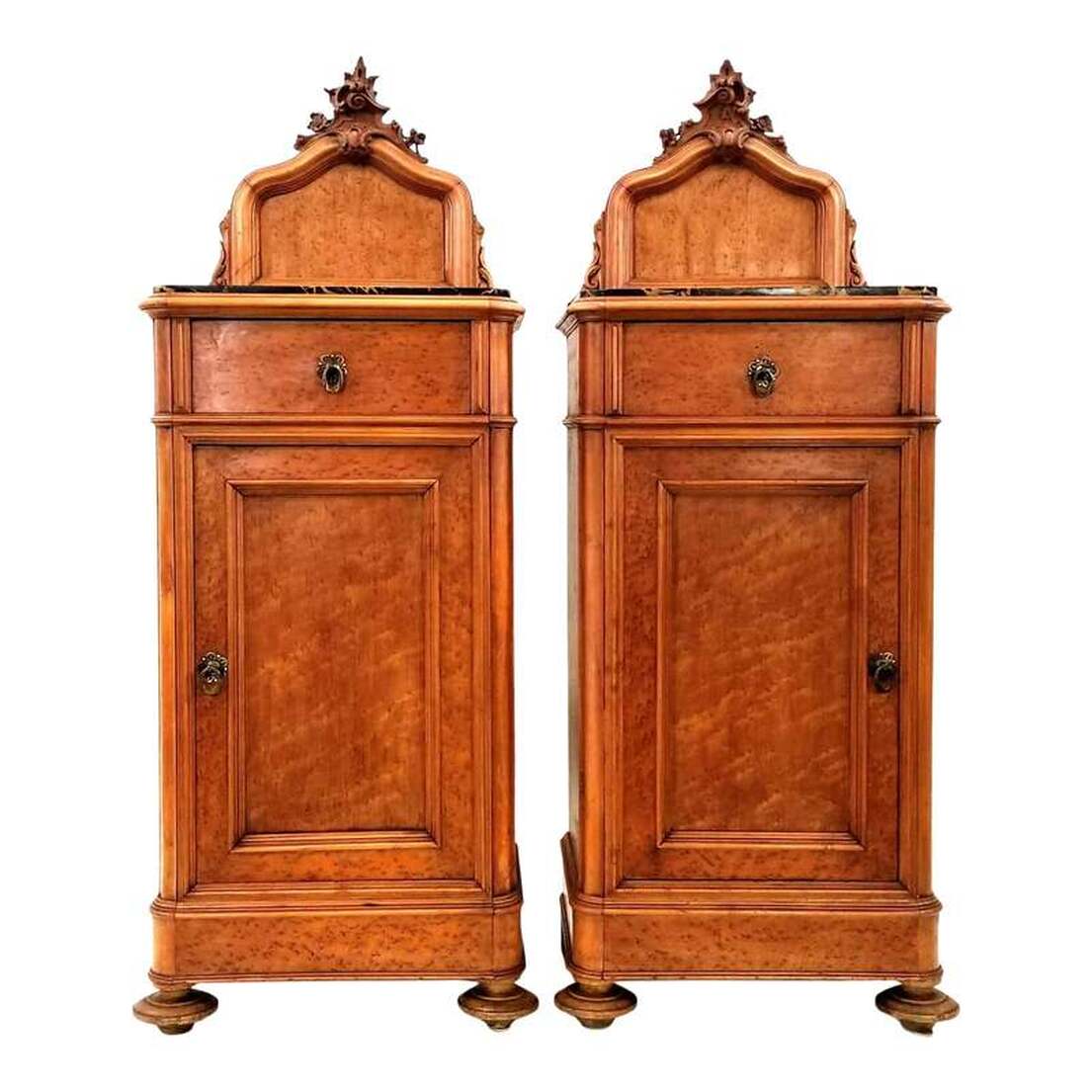Antique pair of somnoe, or half commodes, are ideal for use as bedside cabinets or nightstands.  The pair was made in Northwestern Italy between the 1830s and the 1870s during the Rococo Revival period of the nineteenth century.  The nightstands are constructed of Birdseye Maple wood and trimmed with burled maple wood.  The nightstands are topped with Portoro limestone from Porto Venere, Ligeria, Italy ( also from La Spezia and Lerici on the Italian Riviera ), where it has been quarried sporadically since the 16th century and exported worldwide.  The limestone is black with white calcite filled veins and stylolites and sinuous wider veins and pods of yellow calcite colored by geothite ( iron hydroxide ).  Above the limestone tops are carved rocaille crests, reminiscent of the German muschelwerk, featuring scrolls and foliates. On either side of the crests are scroll and leaf supports.  The corners are rounded and the stiles are molded cyma curves, both popular features in France during the reign of Louis-Philippe ( 1830 - 1848 ).  The top drawers show hand cutting, planing, and dovetailing on the fronts and backs.  The bottom cabinet interiors each feature one shelf and are accessed by opening the inset panel single doors.  Under the bottom front are turned bun feet and under the back are block feet.  Cabinets will complement interiors decorated with elements of Louis-Philippe, Biedermeier, French Rococo, Venetian Baroque, Victorian, and Italian Grotto.  Size:  20