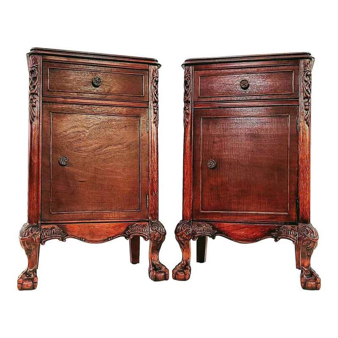 Vintage circa 1930s Joerns Brothers Furniture Company Chinese Chippendale style nightstands.  Pair of nightstands feature a refinished exterior with a classic mahogany tone finish over mixed fruit woods of burl and mottled figures.  The flat tops have molded edges.  The fronts offer access to one top drawer and a single-door cabinet. The drawers and doors are decorated with raised molding, referencing cock-beading on Georgian furniture. The drawers and doors open with a pull on the round chased brass chrysanthemum knobs.  The curved front stiles are decorated with carved foliate pendants and end in cabriole ball-and-claw feet with acanthus leaves and swags on the knees. On either side of the feet, on the curved aprons, are curved and carved wood appliques.  The straight rear stiles end in squared tapered feet.  The sides are constructed with inset panels . One nightstand has top rails applied to the sides, the other does not.  SIZE:  17.75