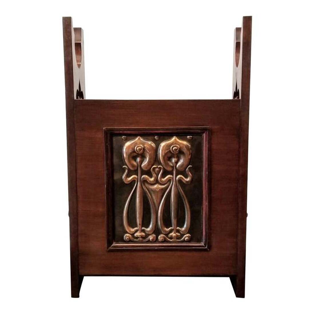Dark stained oak English Arts & Crafts stand for canes, umbrellas, parasols, walking sticks, and swagger sticks. The front panel is repousse copper featuring an Art Nouveau floral pattern. Shapland & Petter made many pieces featuring similar copper design and work. Decorative cutwork on the side panels adds further interest.
